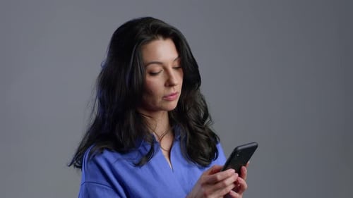 Woman Using Smartphone in Studio Close Up