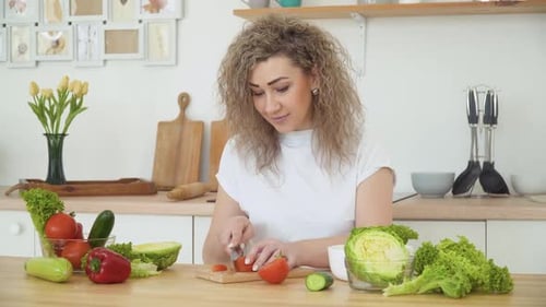 Woman Prepares Healthy Vegetables in Bright Kitchen