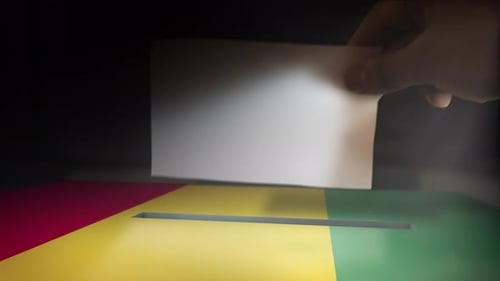 Hand Casting Ballot into Election Box with Flag Colors