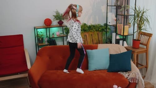 Young Girl Dancing and Listening to Music at Home