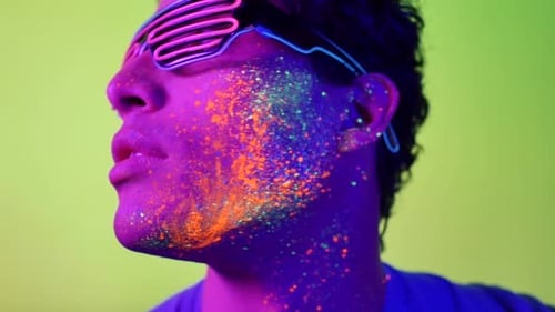 Young Adult with Colorful Makeup and Neon Glasses