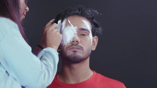 Cream Makeup Applied to Young Man's Face