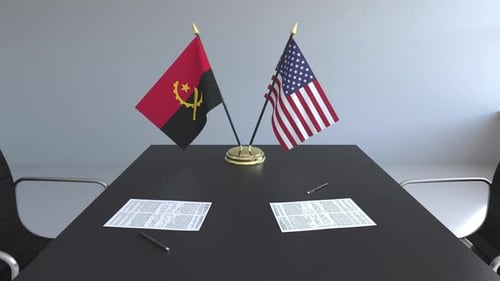 Flags of Angola and the United States on the Table