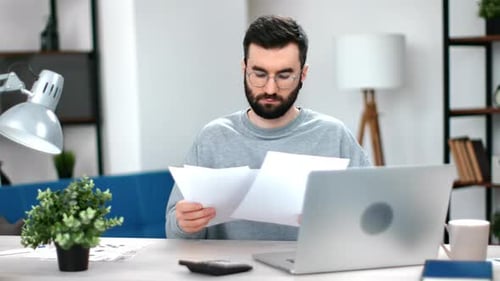 Focused Man Office Employee Checking Paper Documents Report Financial Balance Bill Working at Modern