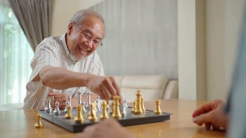 Senior Man Smiling Playing Chess Indoors