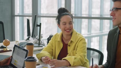 Colleagues Having Discussion at Business Meeting in Office