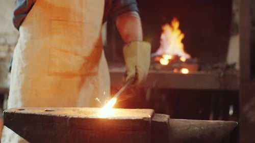 Blacksmith Working Hot Metal at Anvil