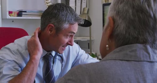 Doctor Talking with Senior Patient in Office