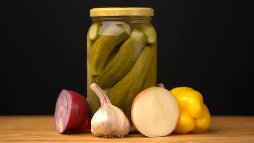 Footage Glass Jars with Salted Vegetables for the Winter Rotated on Table