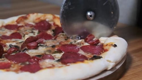 Cutting Pizza with a Round Cutter Knife. Slow Motion 240 Fps