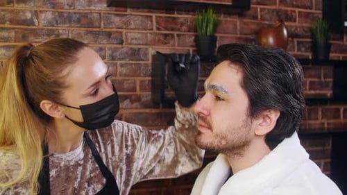 Young Stylish Man in a Beauty Salon. Face and Eyebrow Care