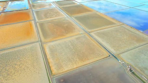 An aerial view from a drone flying over a salt fields, salt production.