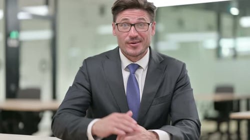 Cheerful Businessman Communicating on a Video Call