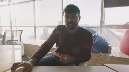 Young Businessman Talking on Video Call in Office