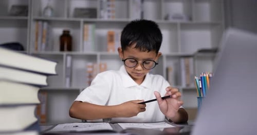 Boy Drawing and Using Laptop at Desk