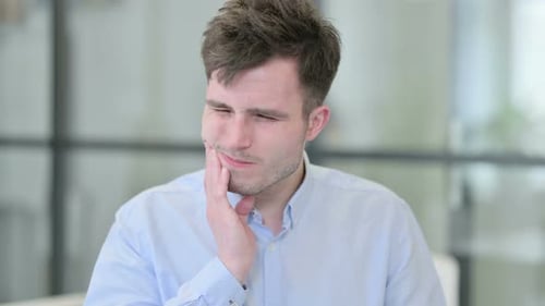 Young Adult with Toothache in the Office