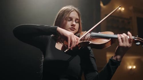 Young Woman Violinist is Playing Violin in Music Hall Portrait of Woman with Fiddle Classic Music