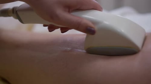 Woman Receiving Medical Massage Treatment on Leg