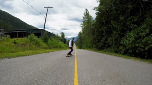 Man skateboarding on the rural road 4k