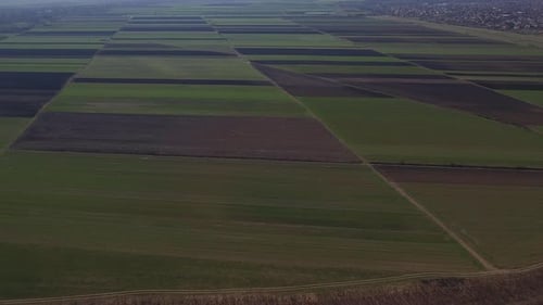 Aerial View of Green Farmland and Tilled Soil