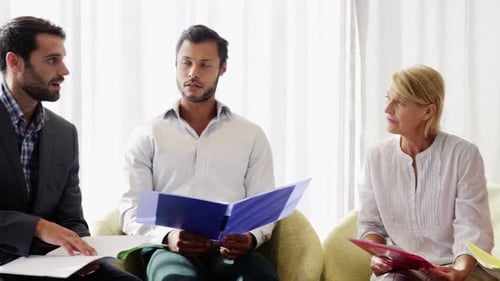 Businessman discussing with his coworker over document