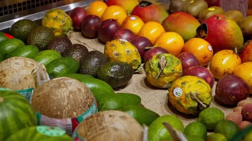 Showcase with Exotic Fruits in Supermarket Closeup View Tropical Food in Grocery