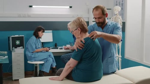 Physiotherapist Doing Physical Therapy Exercise with Old Patient