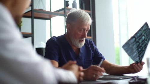 Close-up of Team Professional Doctors Discussing Together History Disease of Patient Using MRI Scan