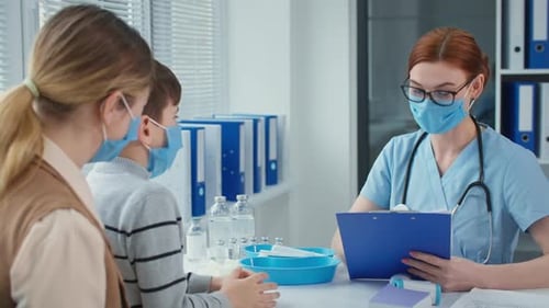 Doctor Consults with Young Boy at Clinic