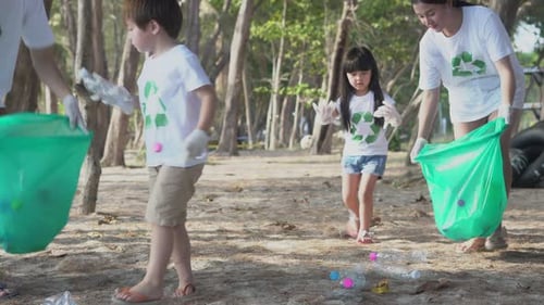 Family Volunteers Clean Beach, Picking Up Trash Together