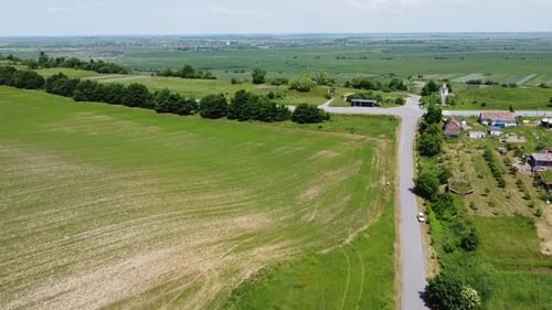 Aerial drone view of a flying over the rural agricultural landscape.