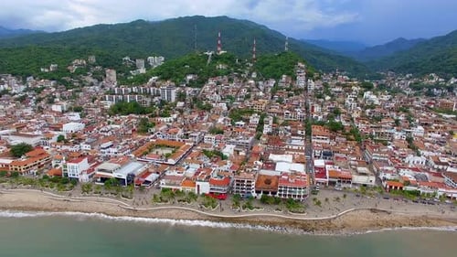 Aerial View of Coastal City Near Mountains