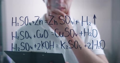 Scientist Studying Chemical Equations on Glass Board