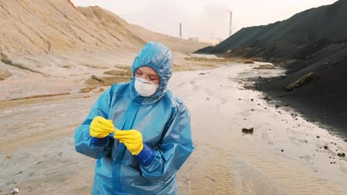 Scientist in Hazmat Suit Examining Environment