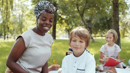 Children Learning Outdoors with their Teacher