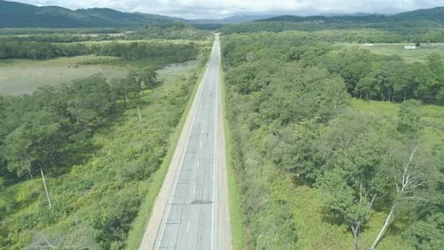 Aerial View Above Cars Driving Along Empty Countryside Road on Sunny Day