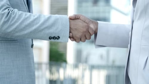 Business Handshake in Modern Office Setting