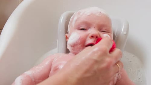 Baby Bathtime with Bubbles and Red Sponge