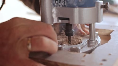 Close Up Footage of Male Caucasian Hands Using Device with Plywood in Slowmotion
