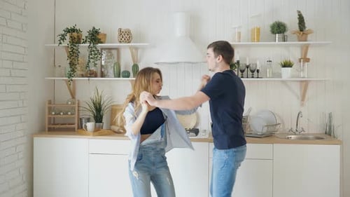 Happy Couple Dancing Together in Their Kitchen