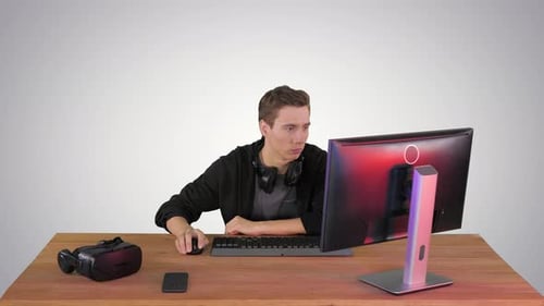 Young Man Gamer Watching Stream Game on Gradient Background.