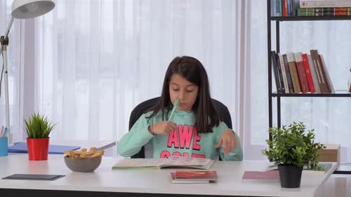 Girl Studying at Desk in Bright Room