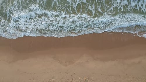 Top view of empty sandy beach and picturesque sea waves
