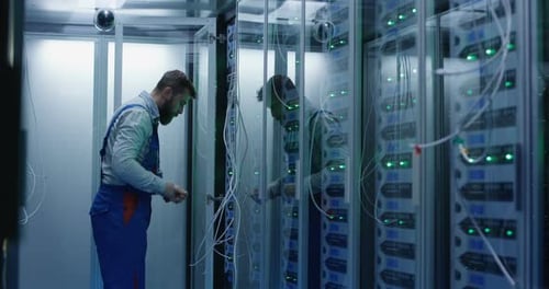 Male Technician Working in a Data Center