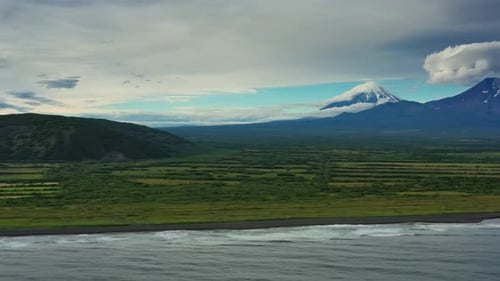 Beach with Black Sand and Volcano