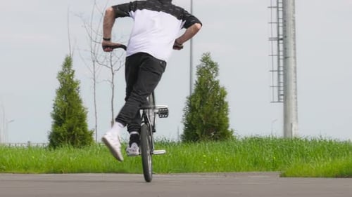 Young Adult Performing Bmx Tricks On Bike