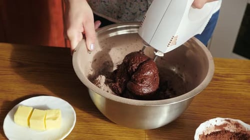 Mixing Chocolate Batter with Electric Mixer in Kitchen