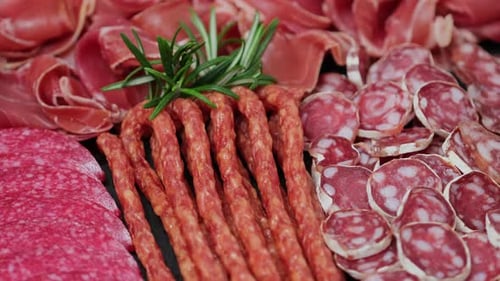 Variety of Cured Meats and Rosemary Close Up