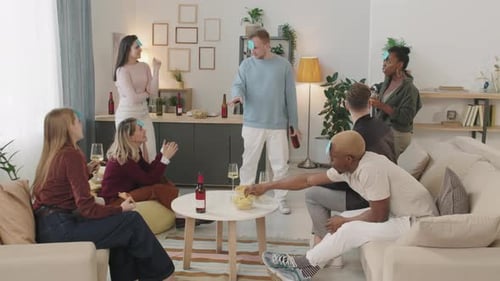 Young People Playing Guessing Game in Apartment