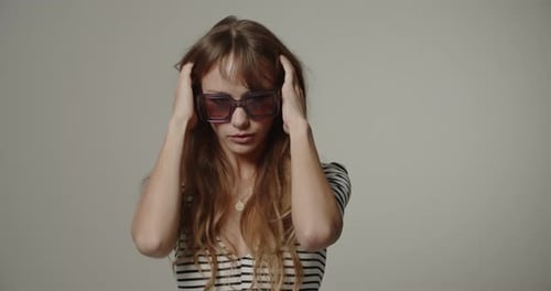 Stylish Woman Puts On Sunglasses and Winks